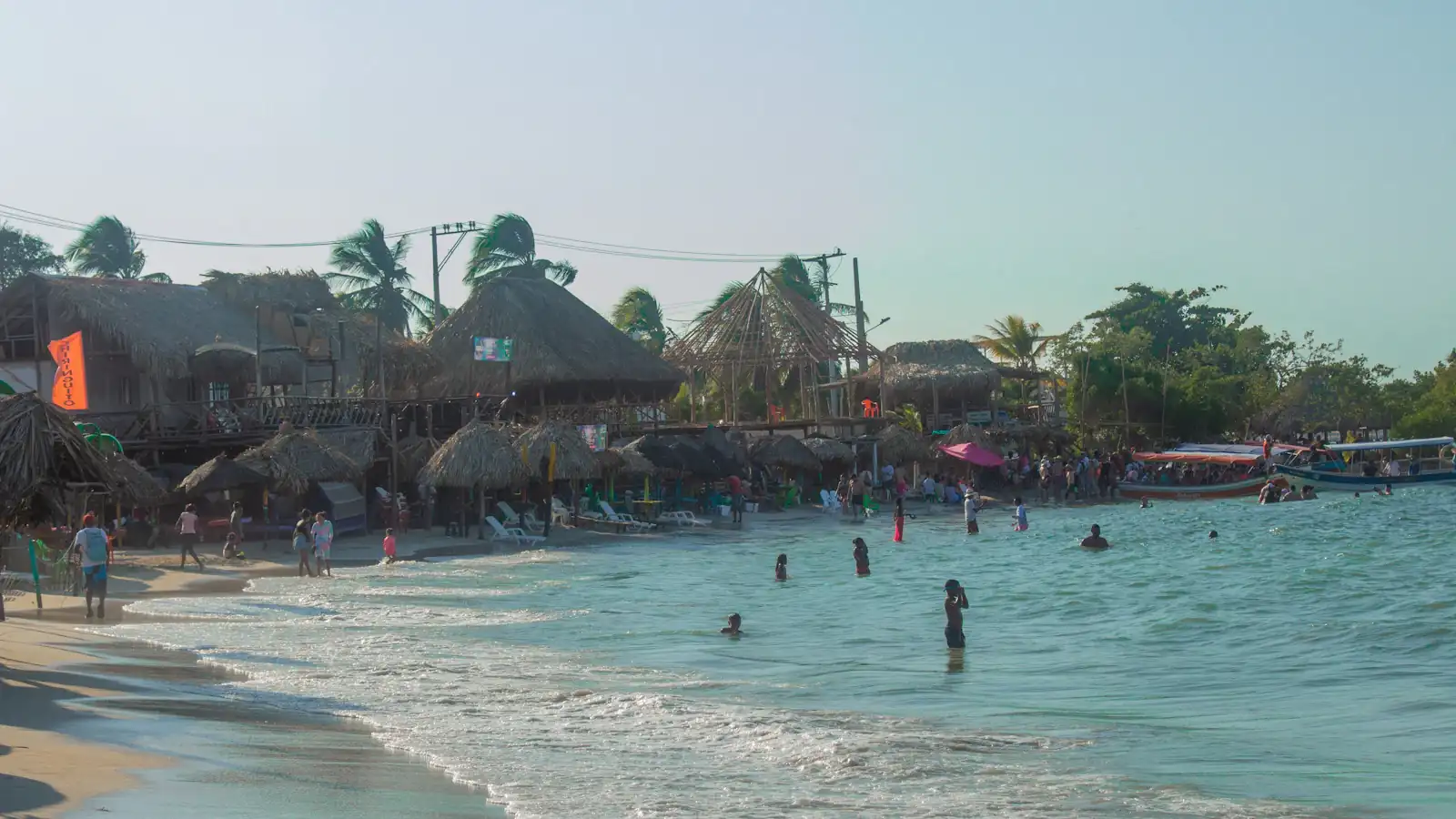 a beach with people and buildings