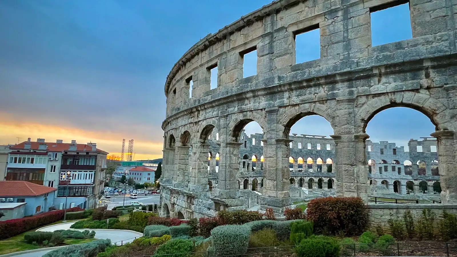 a large stone building with arched windows on top of it