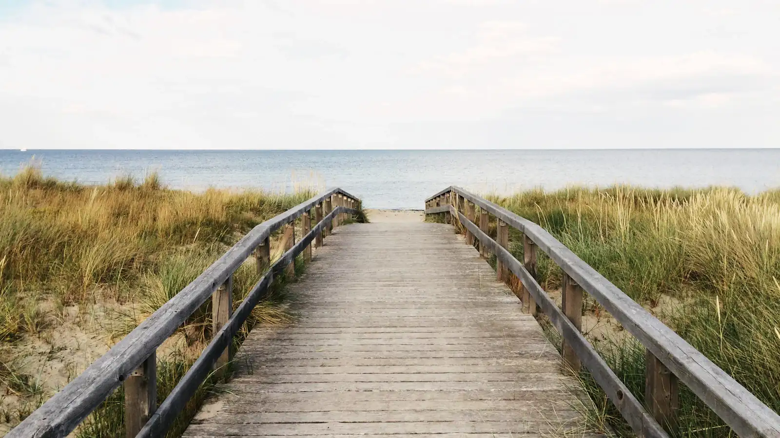 photo of gray wooden bridge