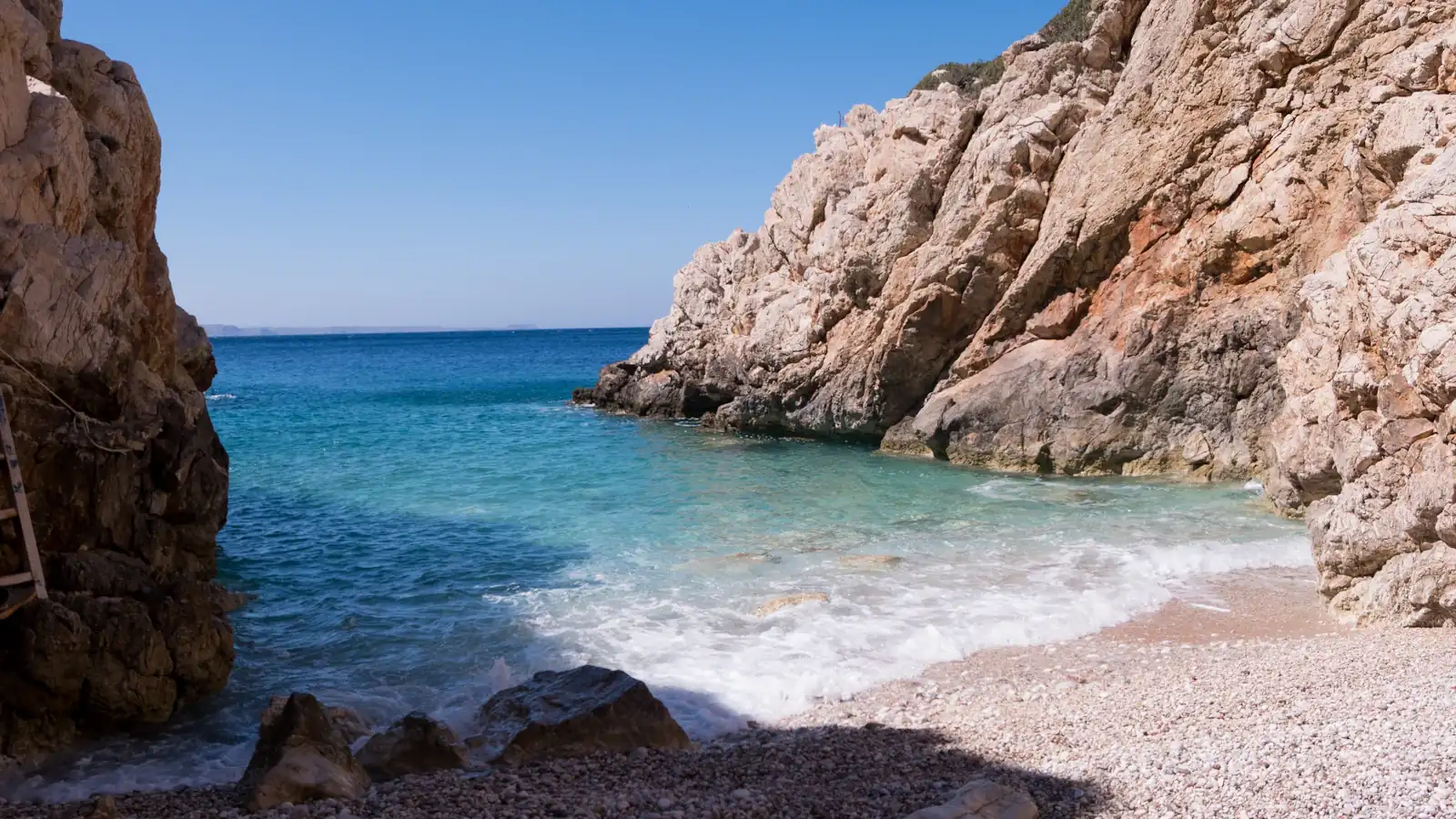 brown rock formation on blue sea under blue sky during daytime