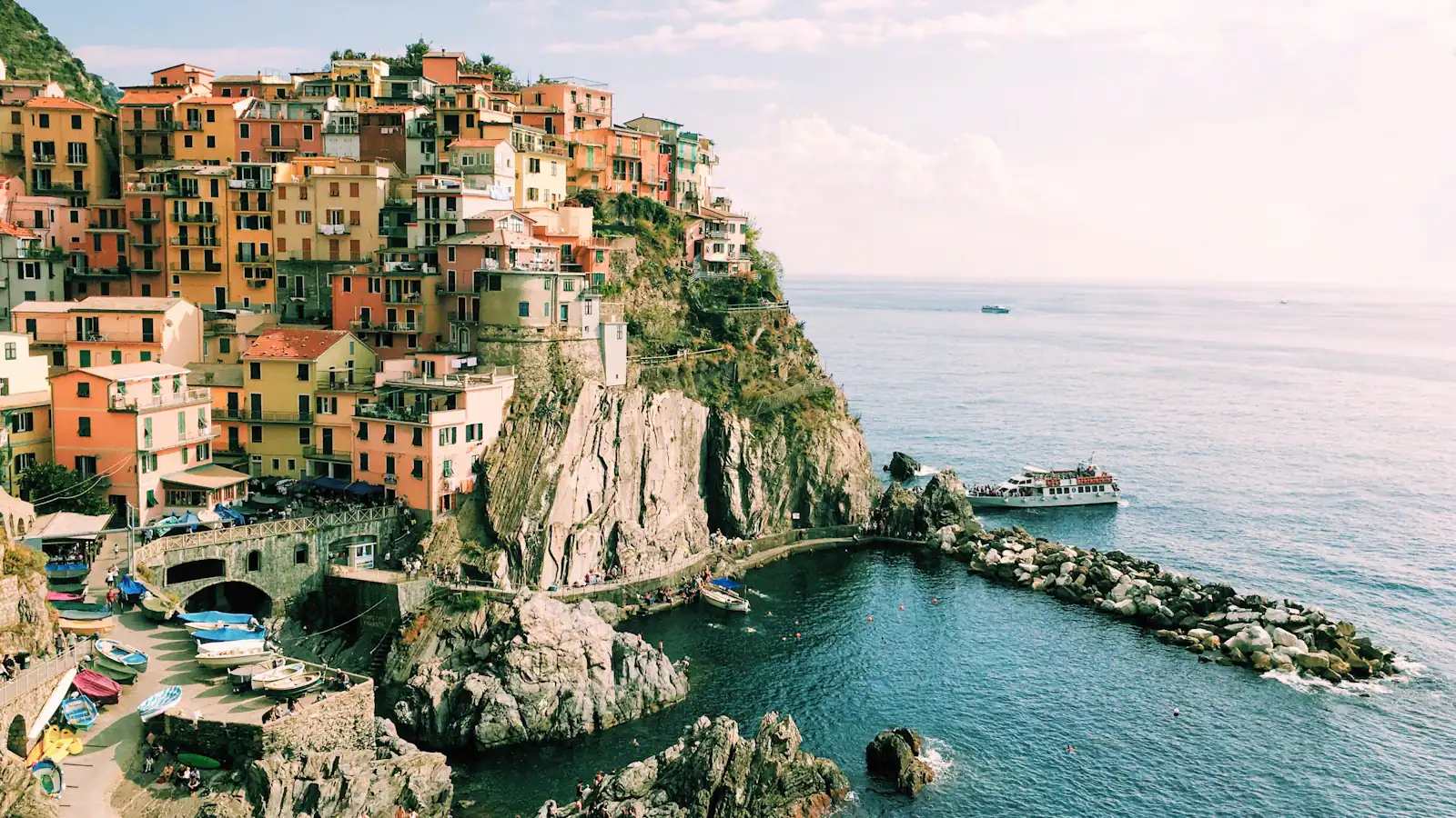 Colorful houses on a cliff above the Mediterranean Sea in Manarola, Italy