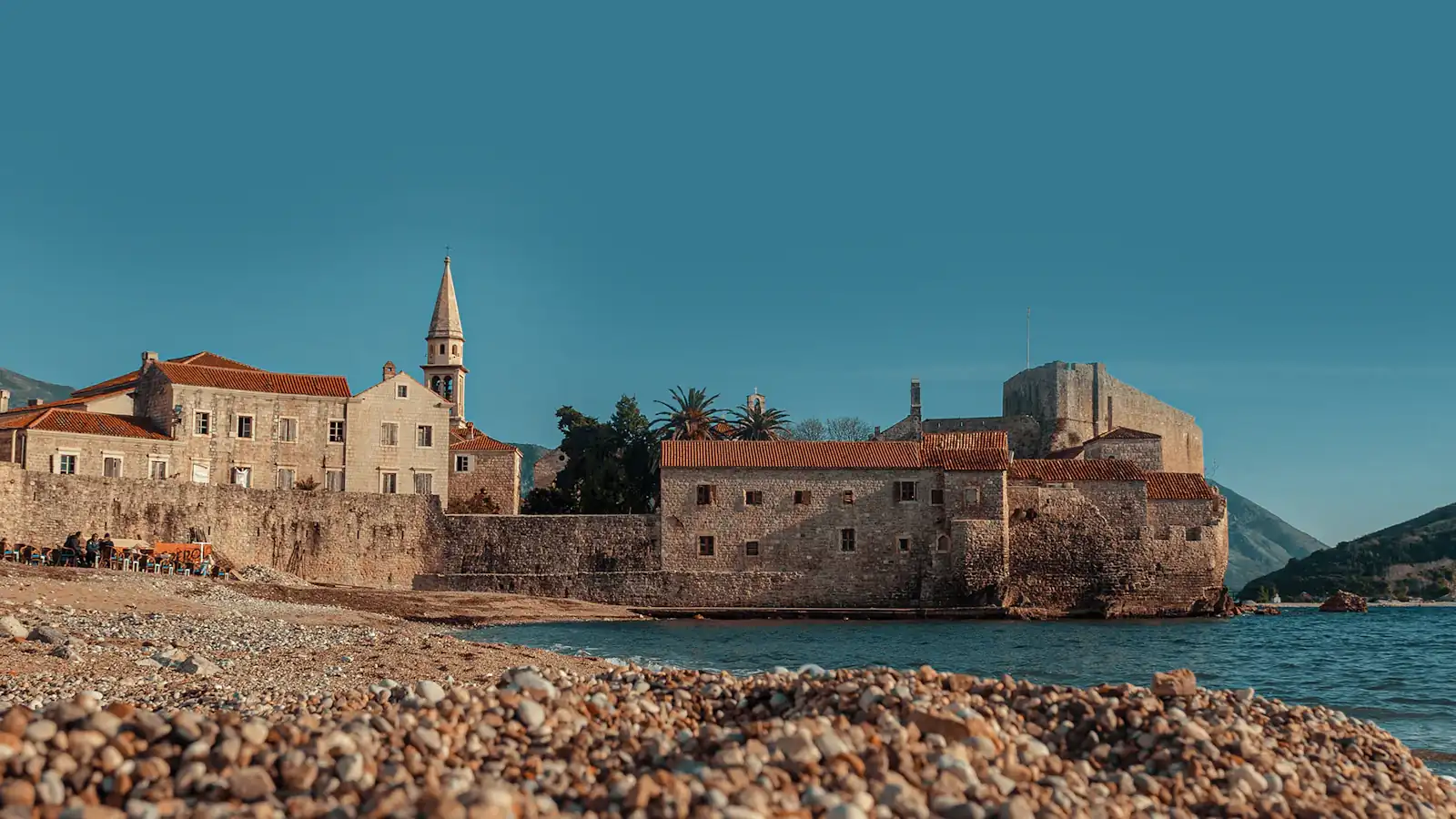 brown concrete building near body of water during daytime