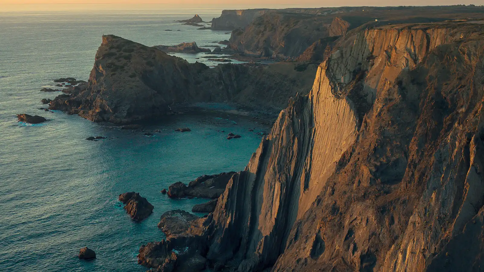 aerial photography of mountain near sea