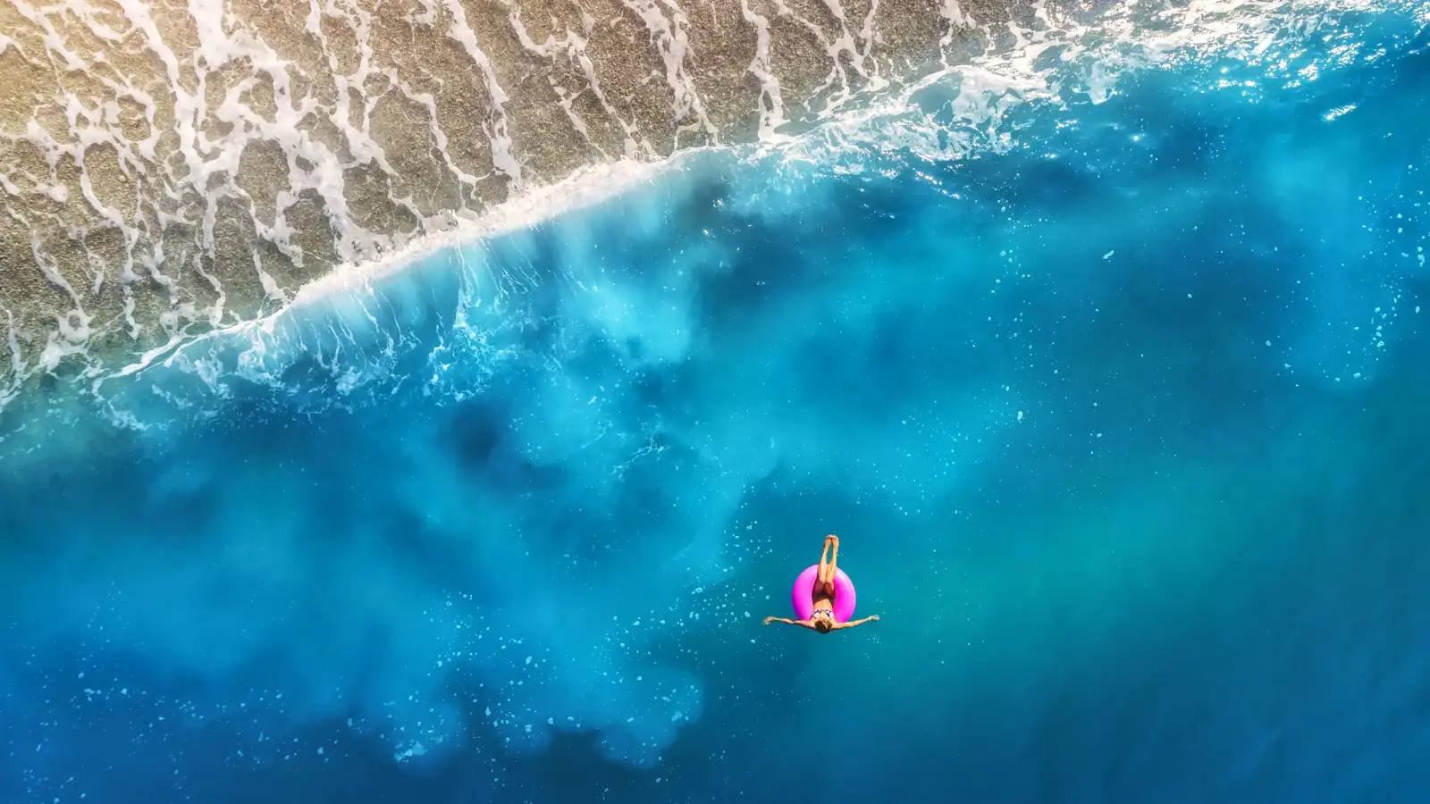 person floating using pink tube